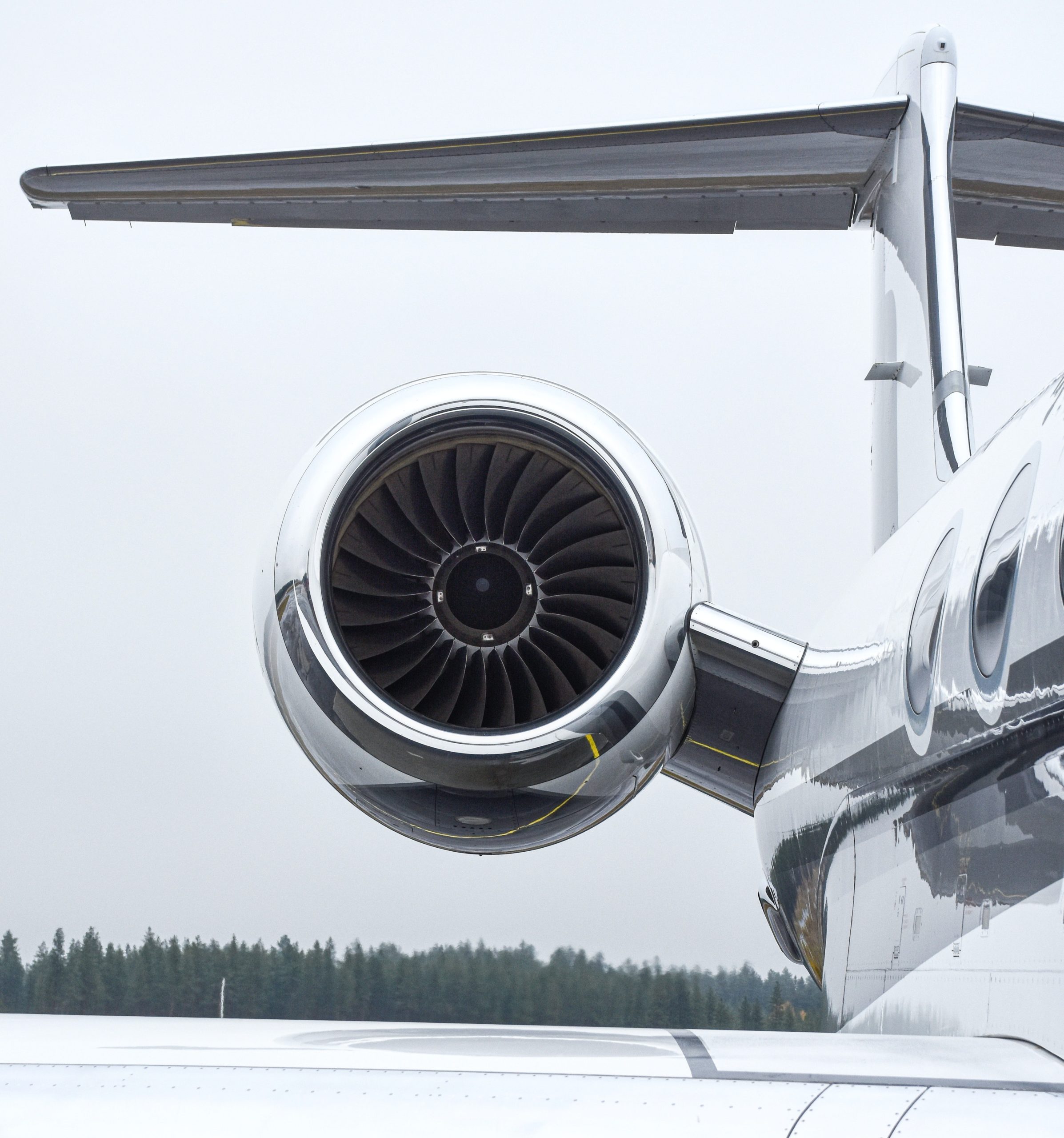 Close-up of a business jet engine and tail on an airport apron