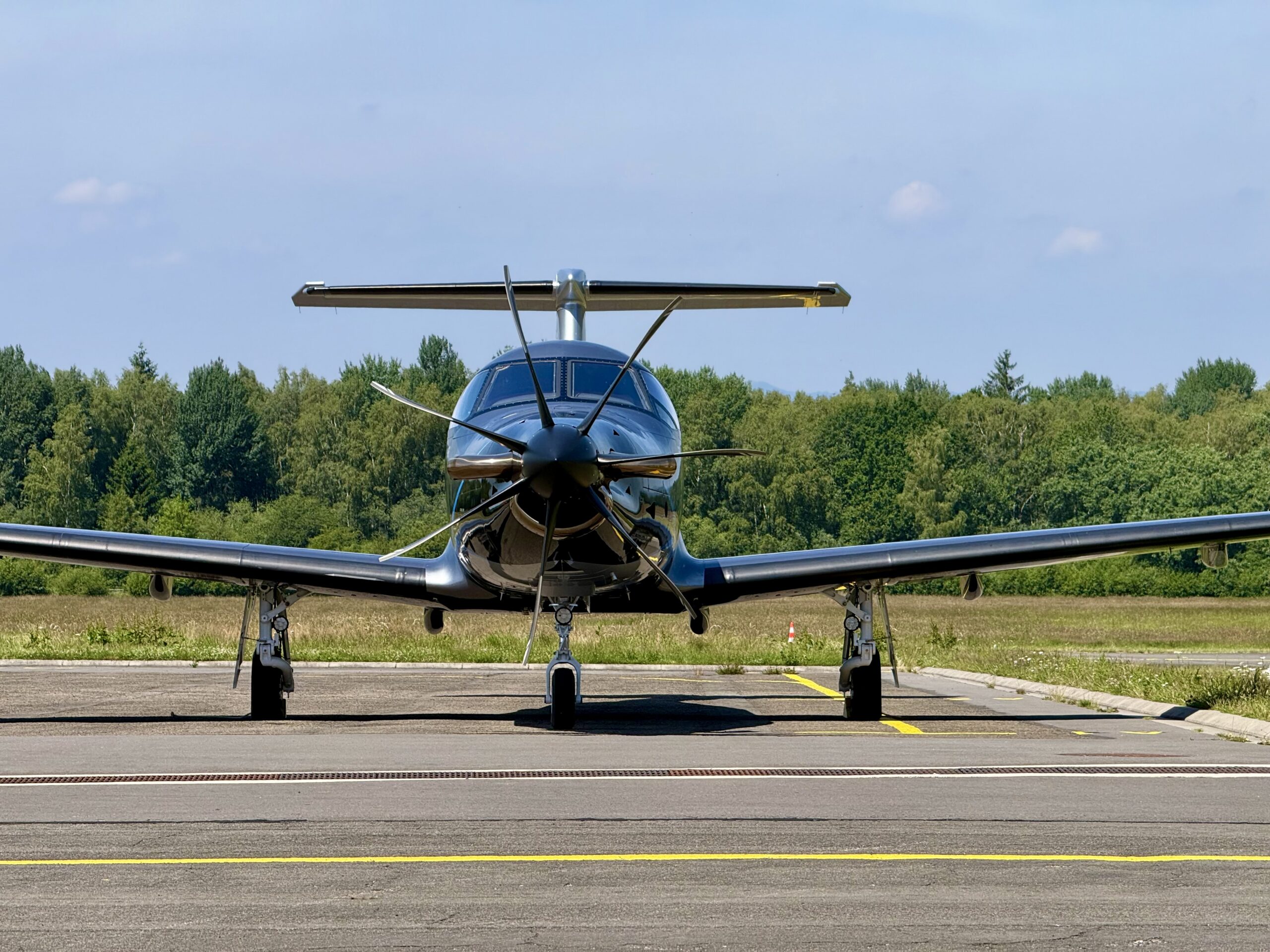 Front view of a Pilatus PC-12 NGX parked on the airport apron of Spa.